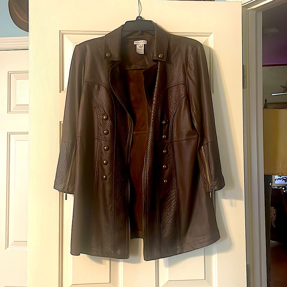 Textured faux leather jacket with brass buttons and zippers.